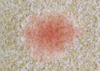 Rotweinfleck aus dem Teppich entfernen